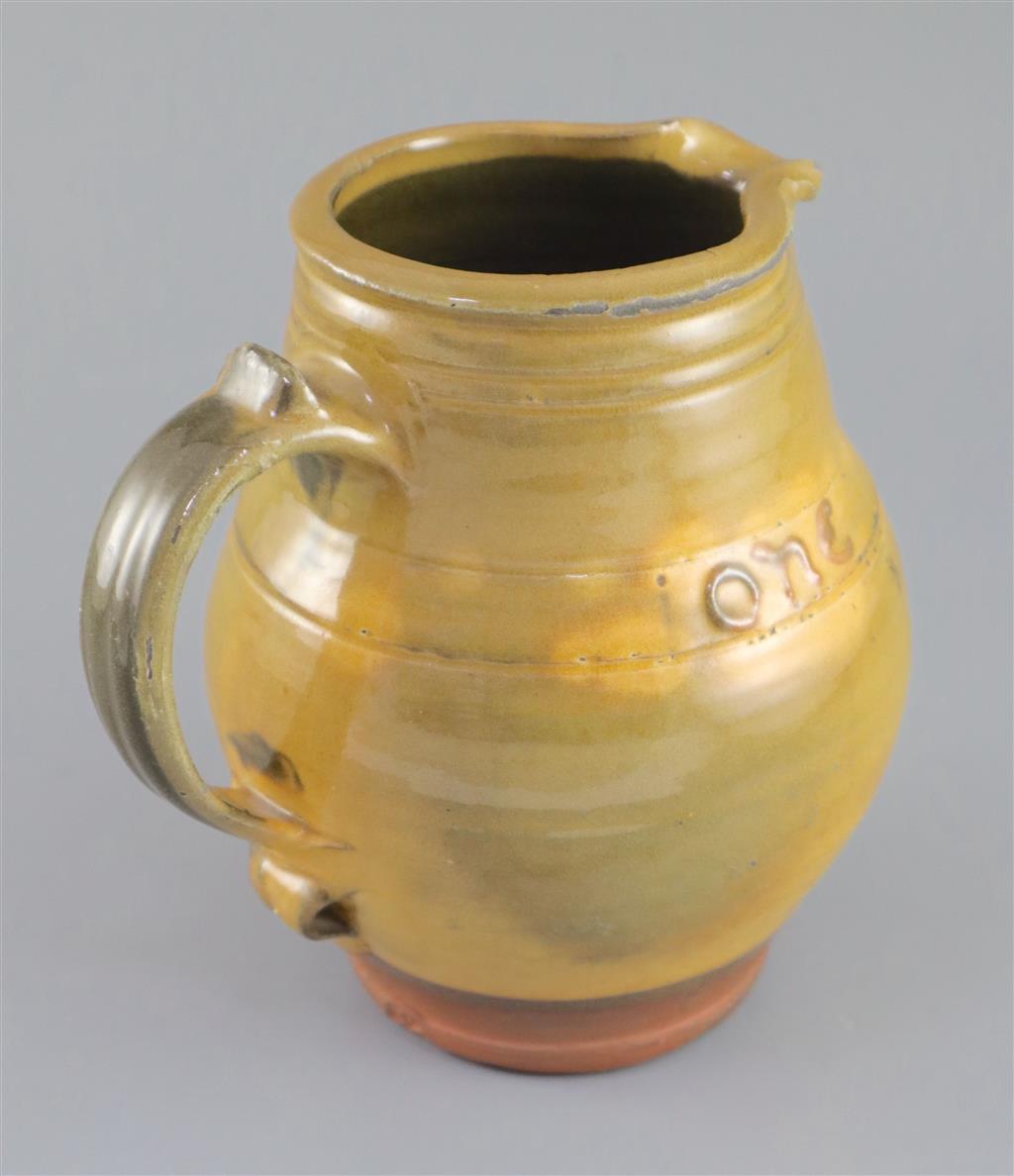 Bernard Howell Leach (1887-1979). A mustard-glazed slipware jug, 17cm high